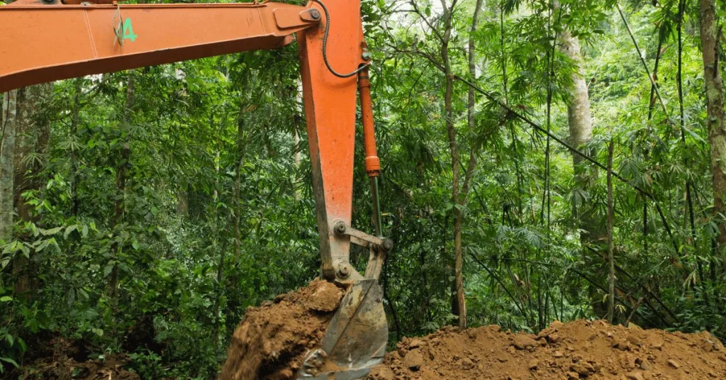 A bulldozer making drenches in the ground to install geothermal piping